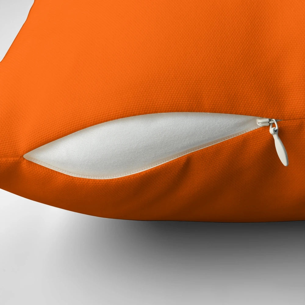 Vivid orange throw pillow with a variety of orange hues