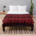 Plush blanket with vibrant Palestinian-inspired red tree design