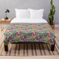 Colorful plush blanket featuring abstract patterns and playful cartoon characters