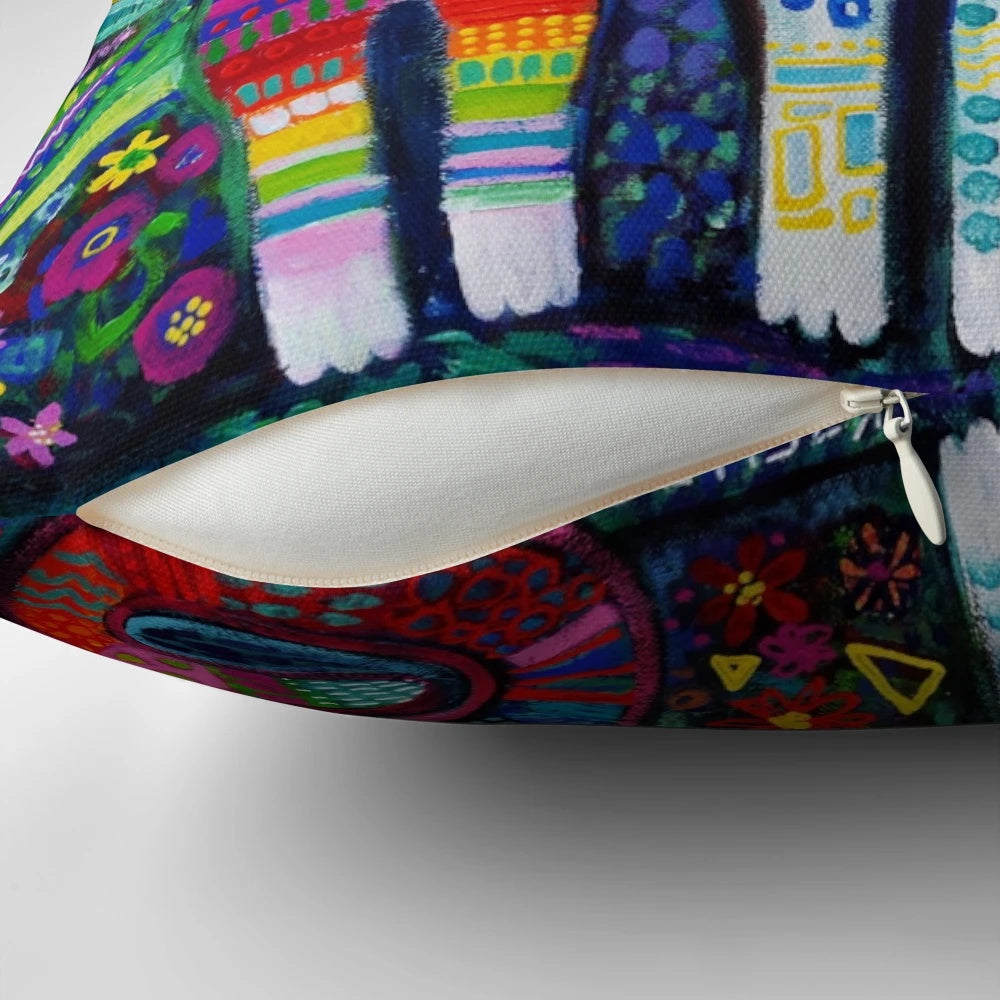 Colorful and whimsical decorative pillow featuring a vibrant pattern of quirky cats in a naive art style