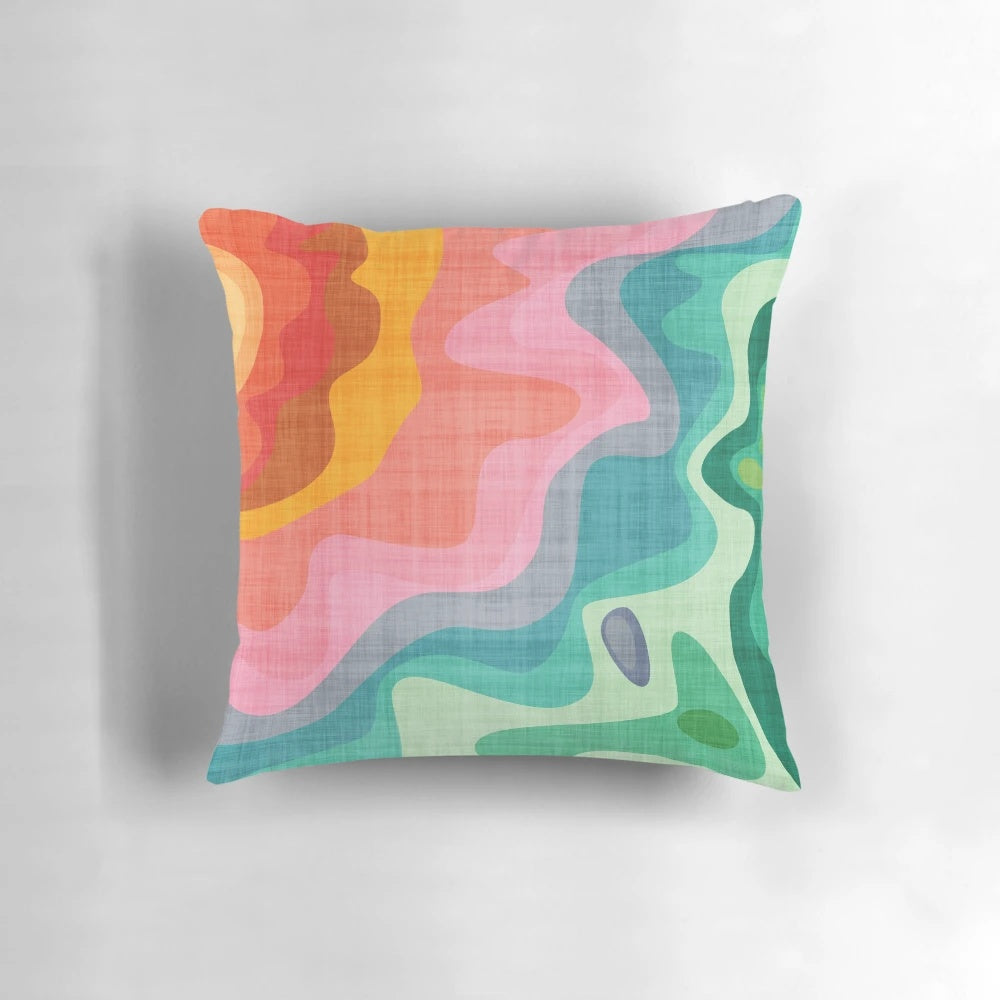 Flouncy, brightly colored rainbow pillow with a fun, abstract pattern