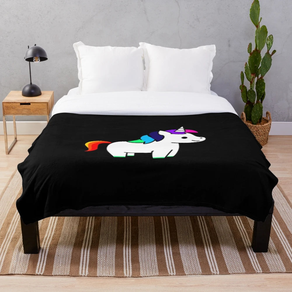 Colorful rainbow plush blanket featuring a whimsical unicorn design