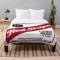 Red stripe plush blanket with beer logo design