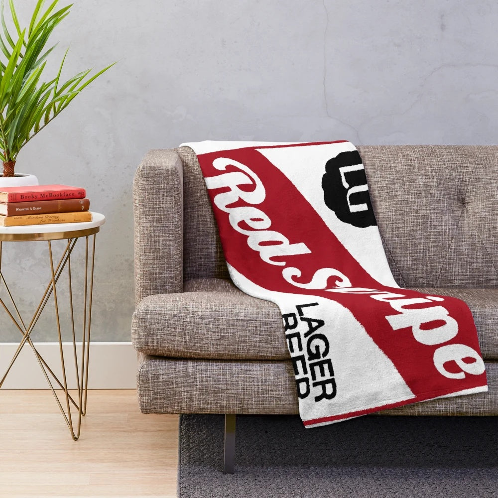 Red stripe plush blanket with beer logo design