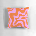 Retro-inspired abstract pattern pillow in hot pink and red-orange with a vibrant swirling design.