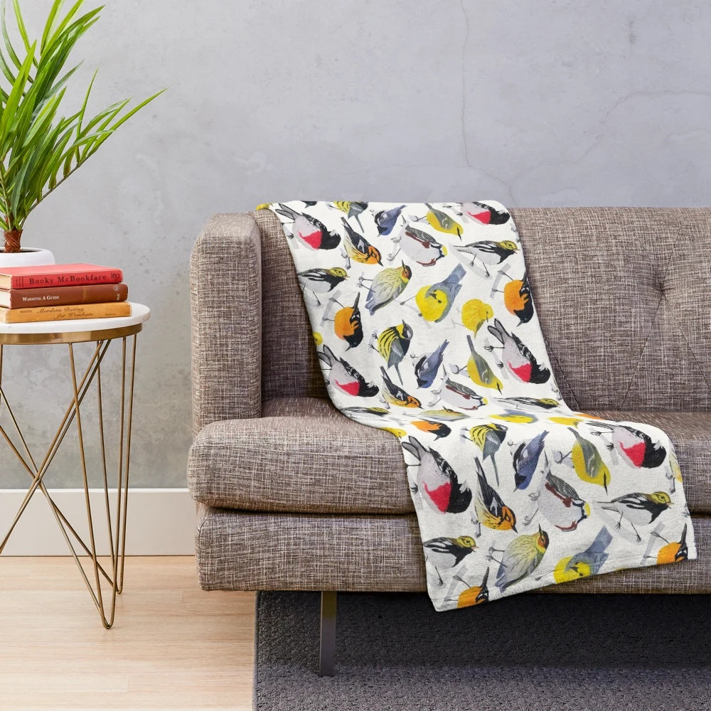 Colorful plush blanket featuring a vibrant watercolor design of birds and flowers