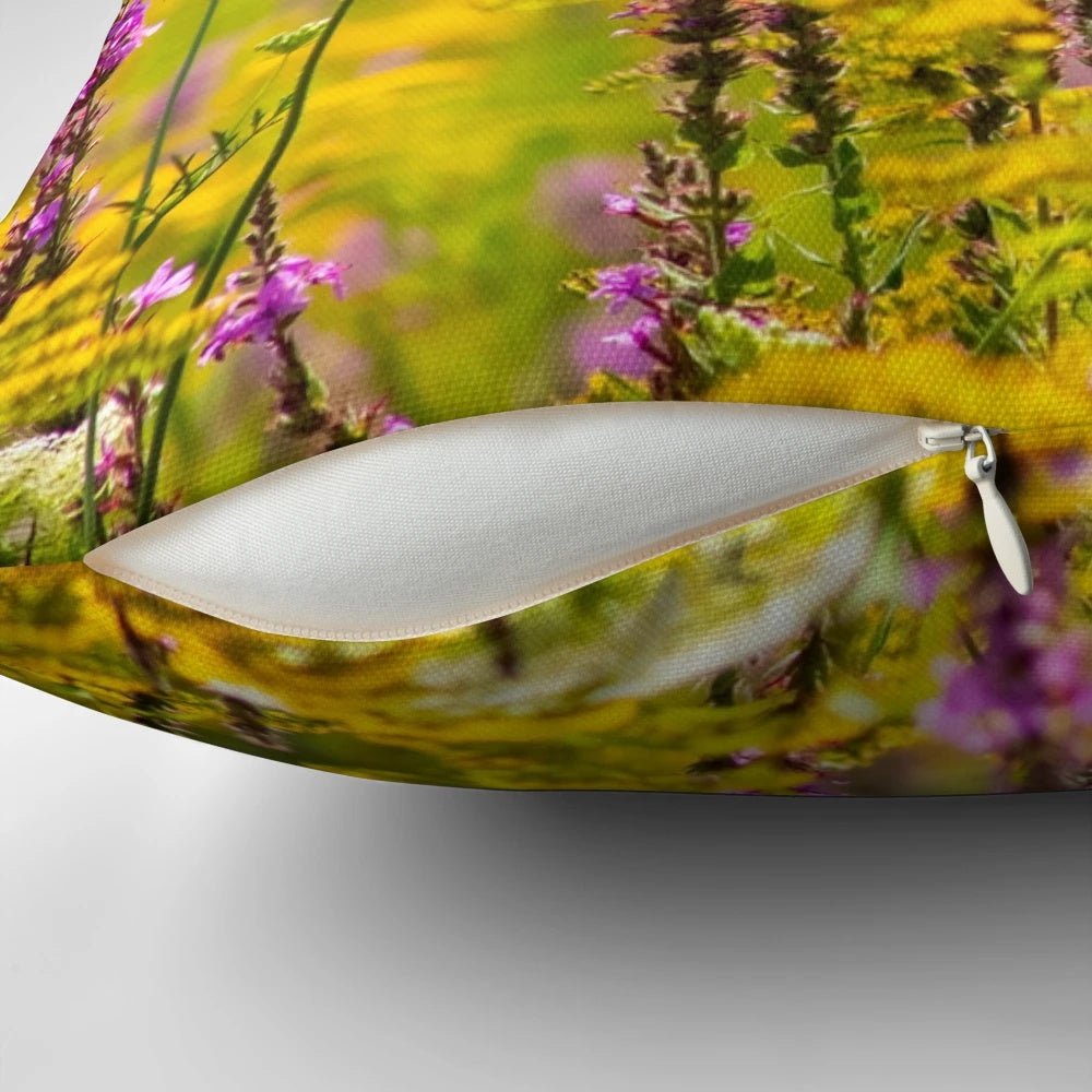 Colorful photograph of a blooming summer meadow printed on a soft, decorative pillow