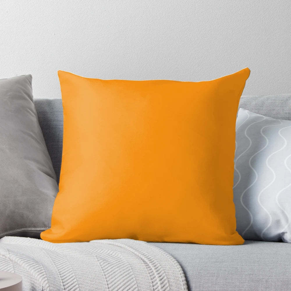 Vibrant tangerine-colored pillow with a solid, plain design, showcasing a range of orange hues.