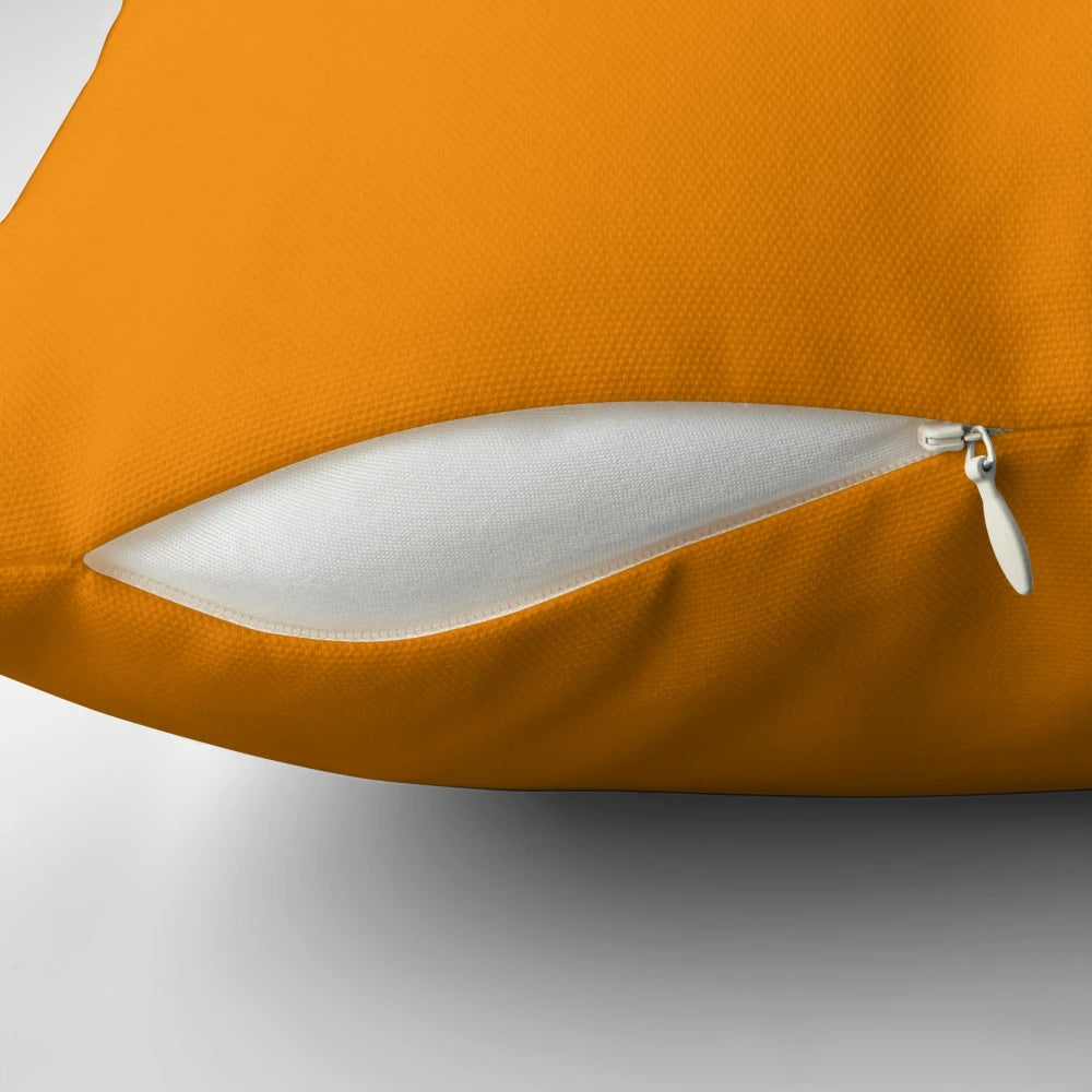Vibrant tangerine-colored pillow with a solid, plain design, showcasing a range of orange hues.