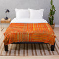 Tribal ethnic geometric pattern gold on orange plush blanket