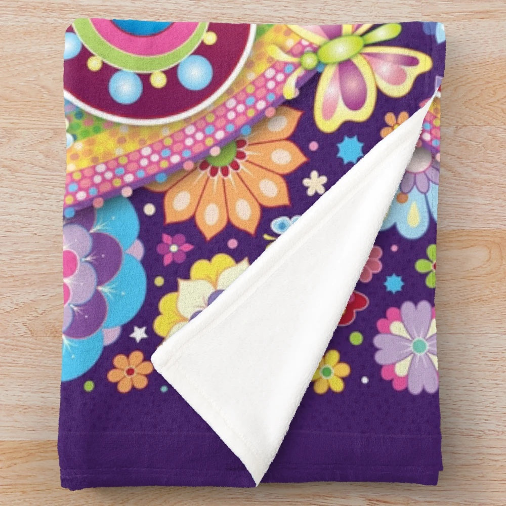 Colorful unicorn inspired plush blanket with rainbow, flowers, and butterflies
