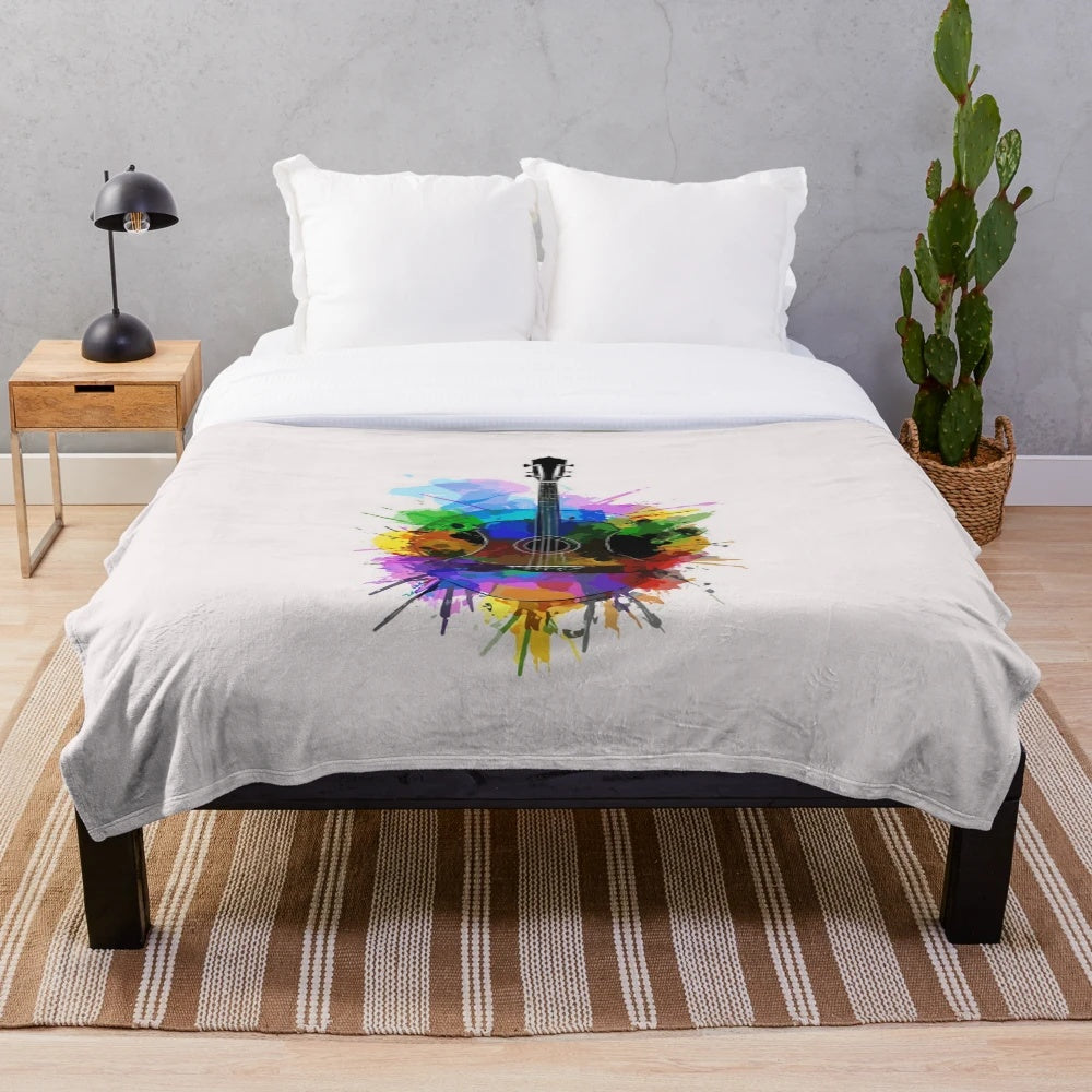Colorful watercolor guitar design on a plush blanket