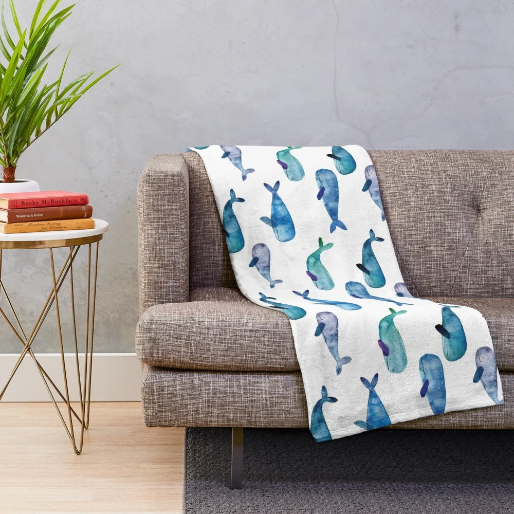 Soft, cozy plush blanket featuring vibrant watercolor whales