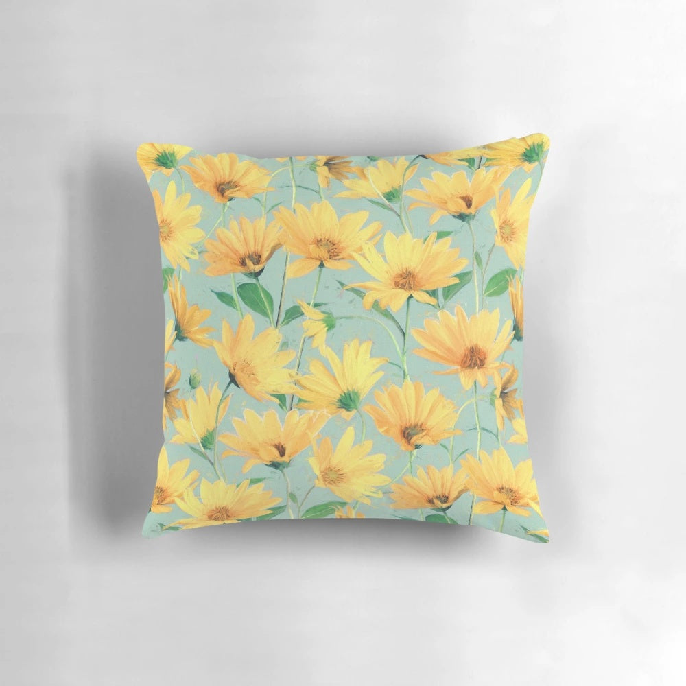 Vibrant yellow daisies painted on a soft sage green pillow, perfect for cottage core home decor.