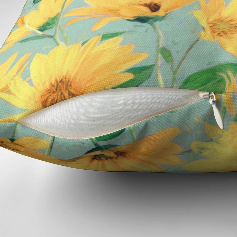 Vibrant yellow daisies painted on a soft sage green pillow, perfect for cottage core home decor.