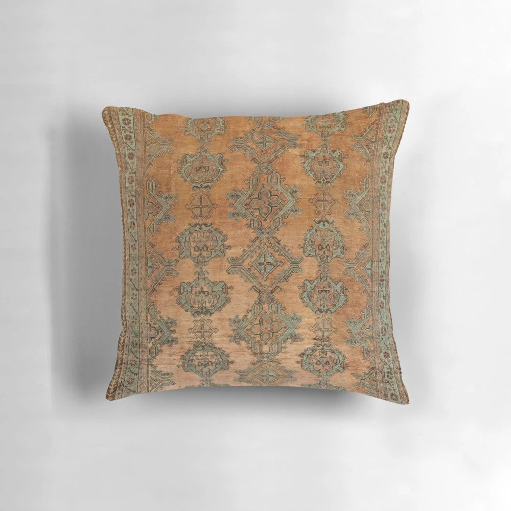 Antique Turkish Oushak rug print pillow with floral and geometric patterns in warm copper and nature-inspired colors.