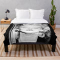 Vintage black and white portrait of Marilyn Monroe on a plush blanket