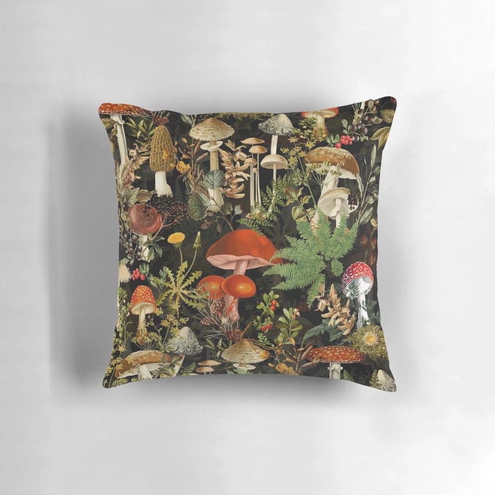 A decorative pillow featuring a vintage botanical pattern of midnight mushrooms in a forest night garden design.