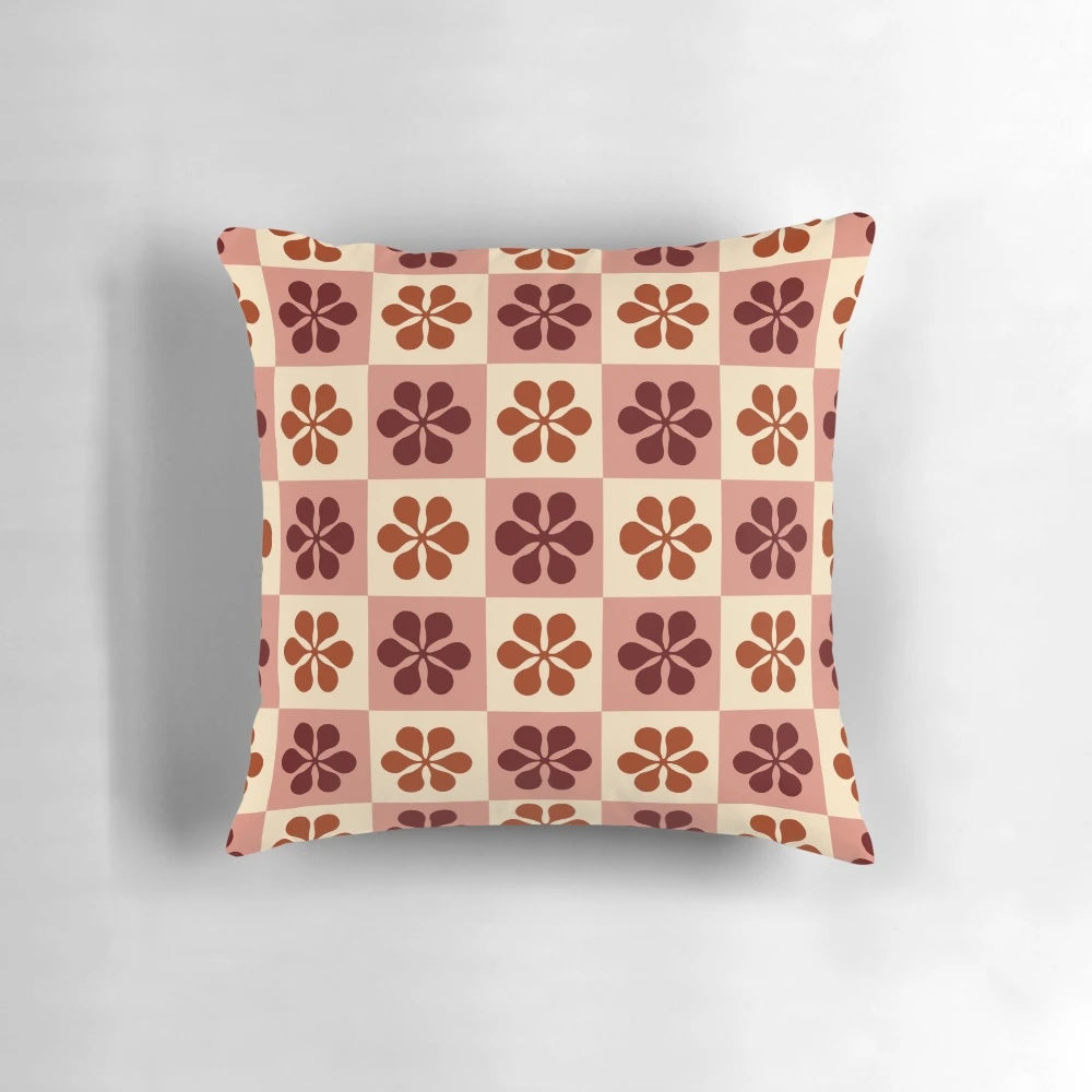 Burgundy and mauve checkerboard pattern pillow with a vintage floral design, perfect for adding a touch of retro style to any room.