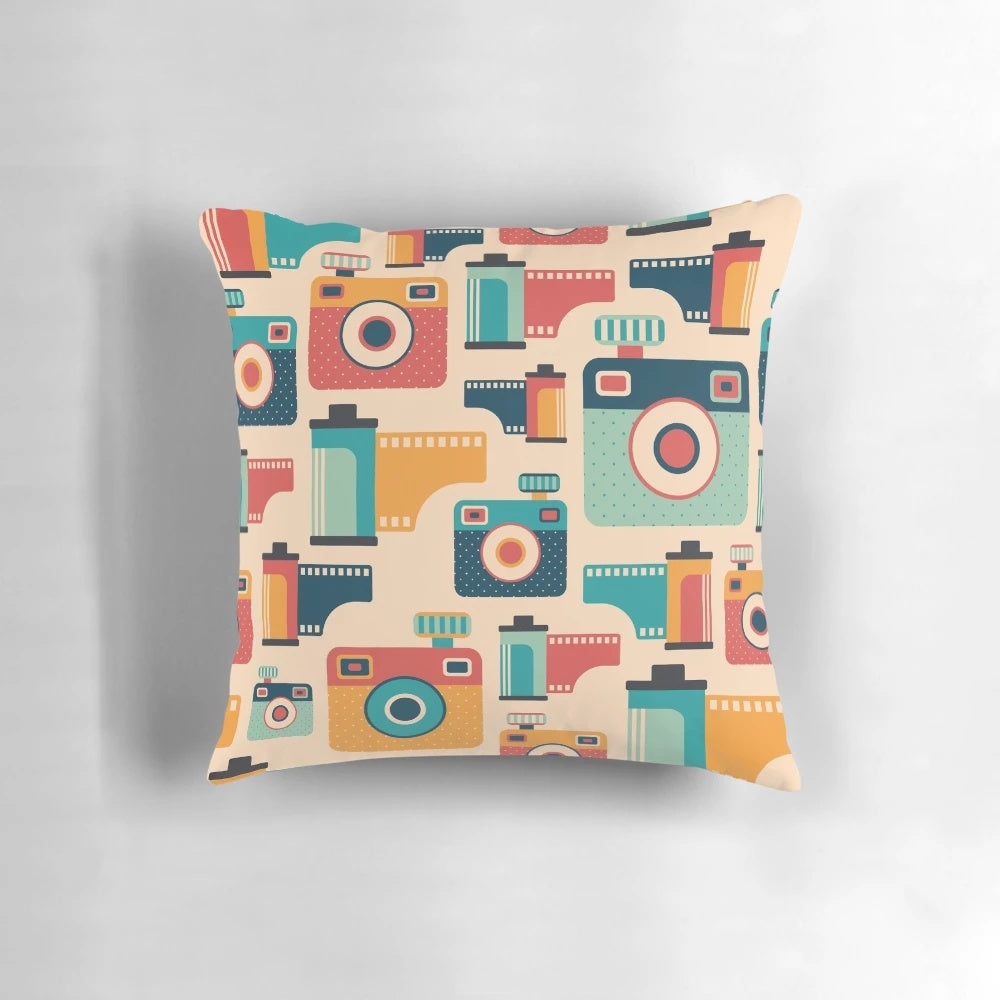 Throw pillow with a vintage camera and film roll graphic design, perfect for home decor and photography enthusiasts.