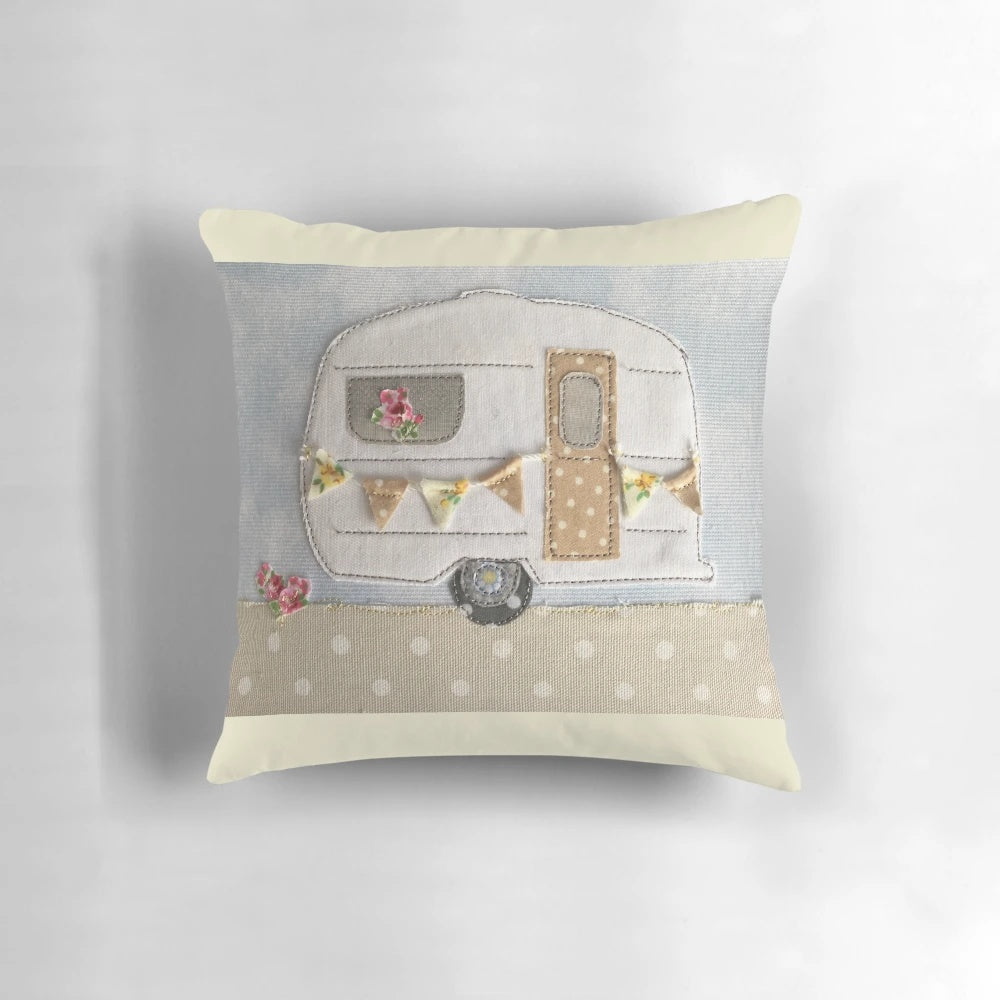 Vintage-inspired caravan-themed decorative pillow with machine embroidered floral stitching
