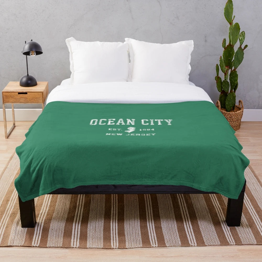 Vintage-style plush blanket with athletic sports design featuring Ocean City, New Jersey imagery