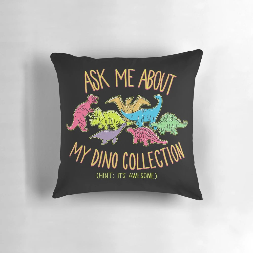 A soft, plush pillow featuring a colorful, retro-style design of various dinosaur species.
