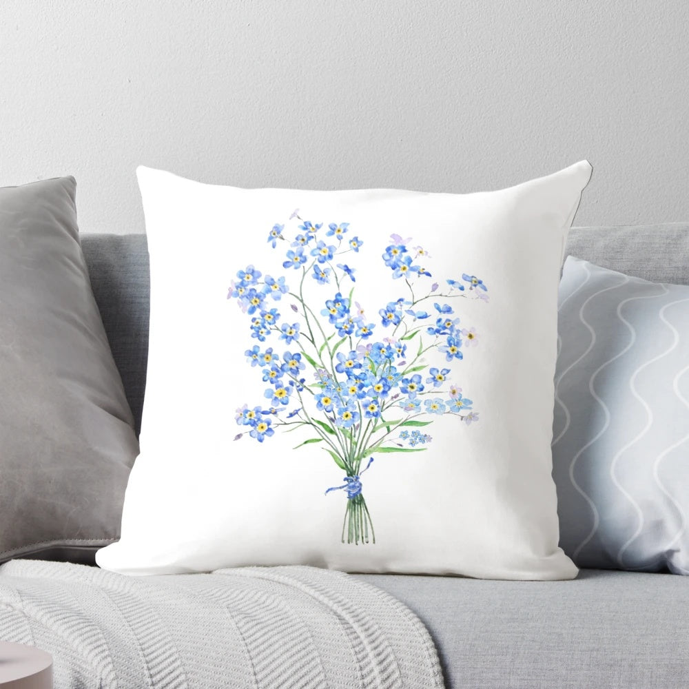 Vintage-style pillow with a hand-painted bouquet of forget-me-not flowers in shades of blue, green, and white against a neutral background.