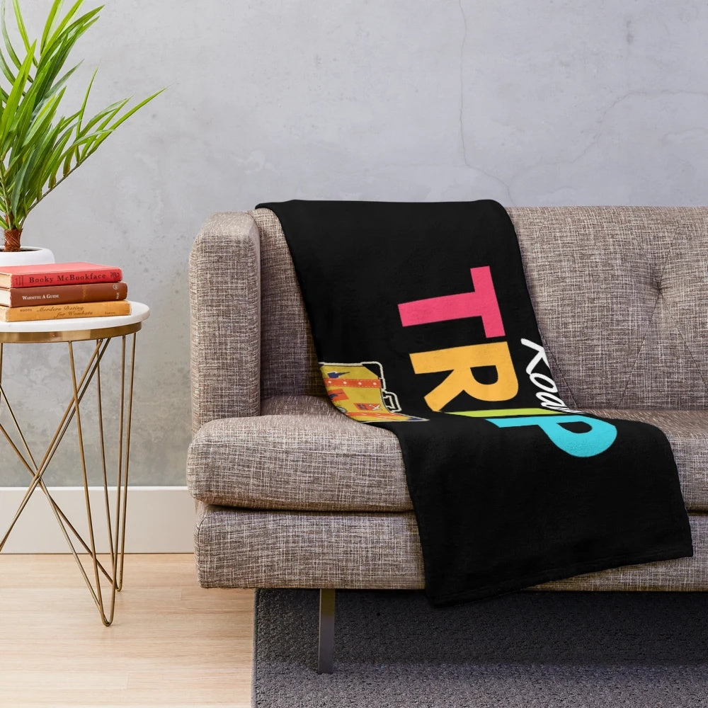 Vintage-inspired plush blanket with retro suitcase and mountain landscape design