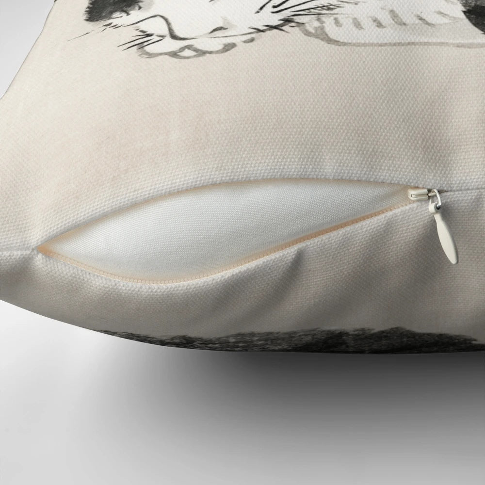 A vintage-style Japanese print of a sleeping cat on a decorative pillow.