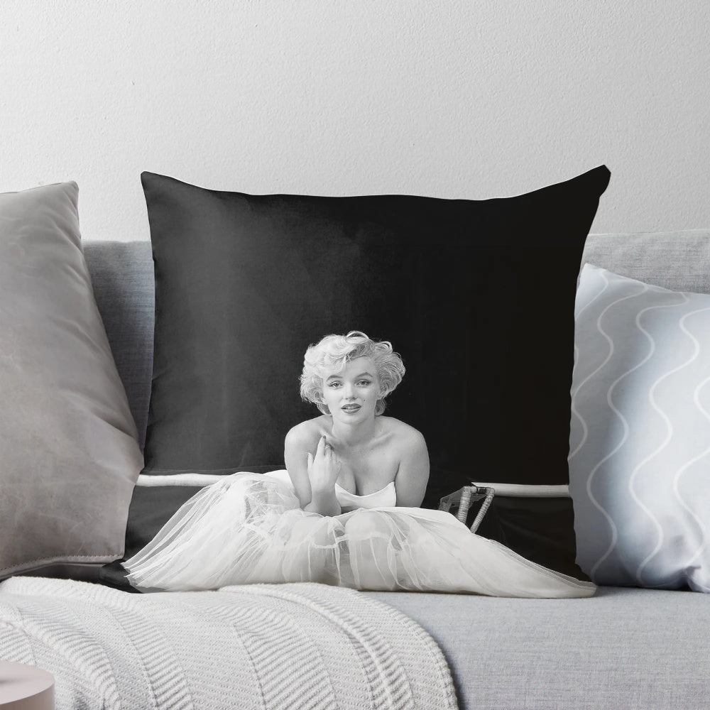 Vintage black and white Marilyn Monroe portrait on a throw pillow, featuring the iconic Hollywood actress in a white dress against a minimalist background.