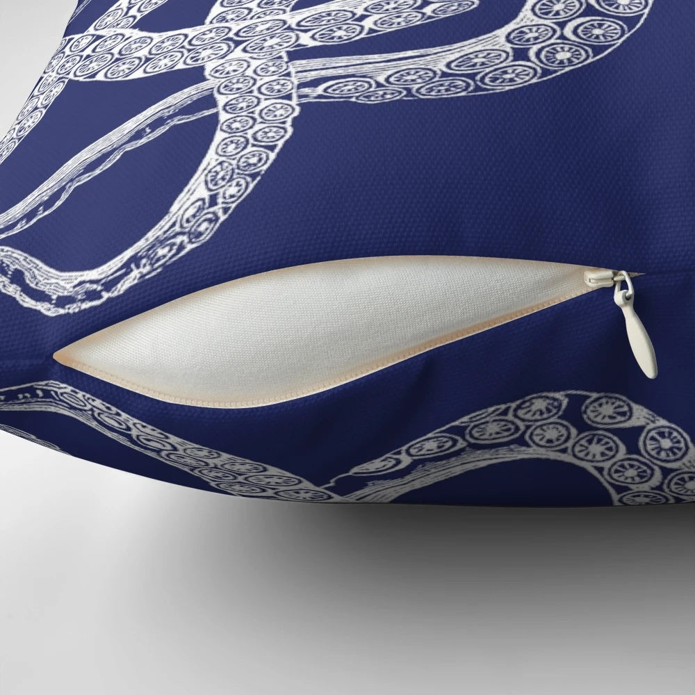 Vintage octopus illustration printed on a navy blue and white nautical-inspired pillow