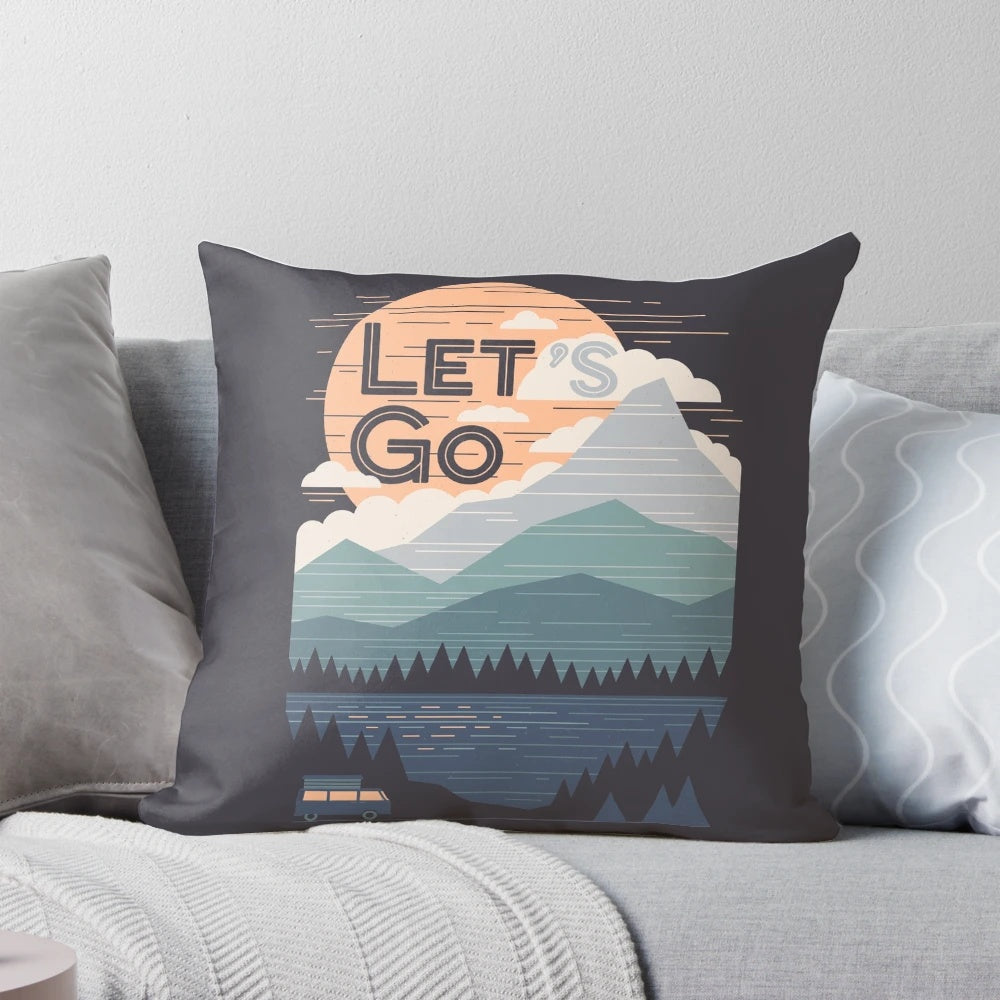 Vintage pastel colored pillow with graphic design of mountains and outdoor adventure quote