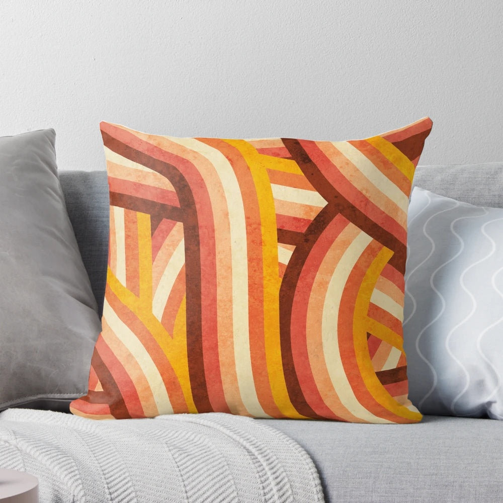Vintage-style orange, brown, and cream striped pillow with a vibrant rainbow pattern
