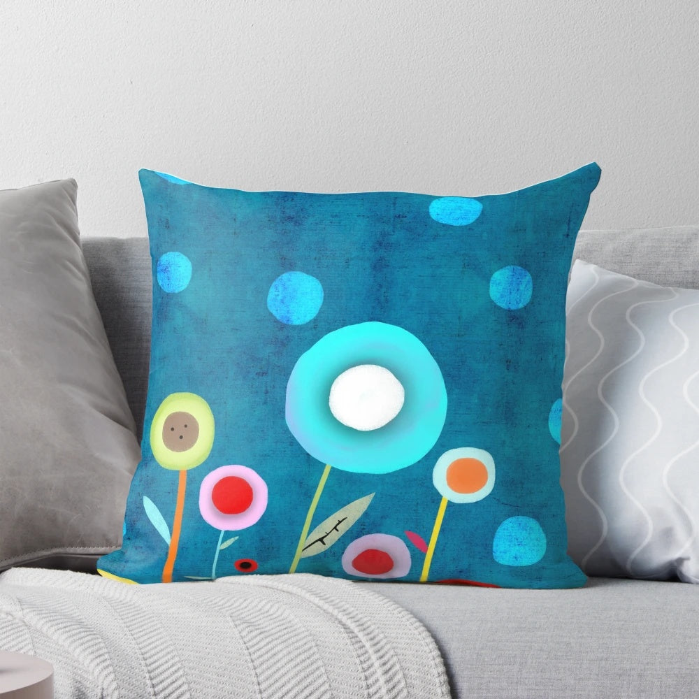 Vintage-inspired turquoise polka dot pillow with distressed blue floral pattern