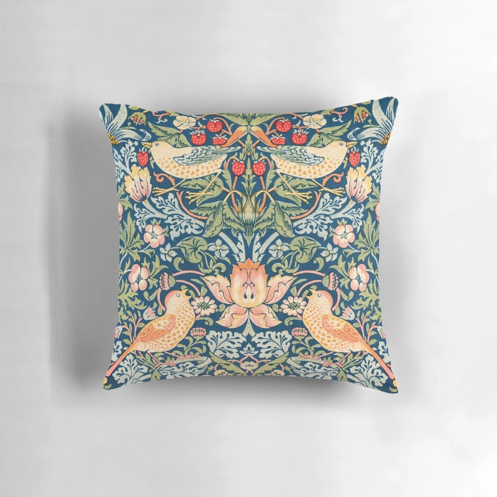 Detailed illustration of the William Morris 'Strawberry Thief' pattern featuring ornate birds and strawberries on a vintage-inspired pillow.