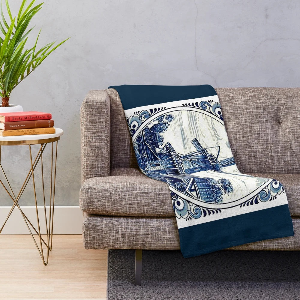 Vintage windmill print plush blanket featuring a whimsical Dutch Blue Delft style design