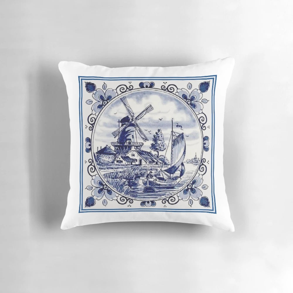 Vintage-inspired blue and white printed pillow featuring a Dutch Delft style windmill scene