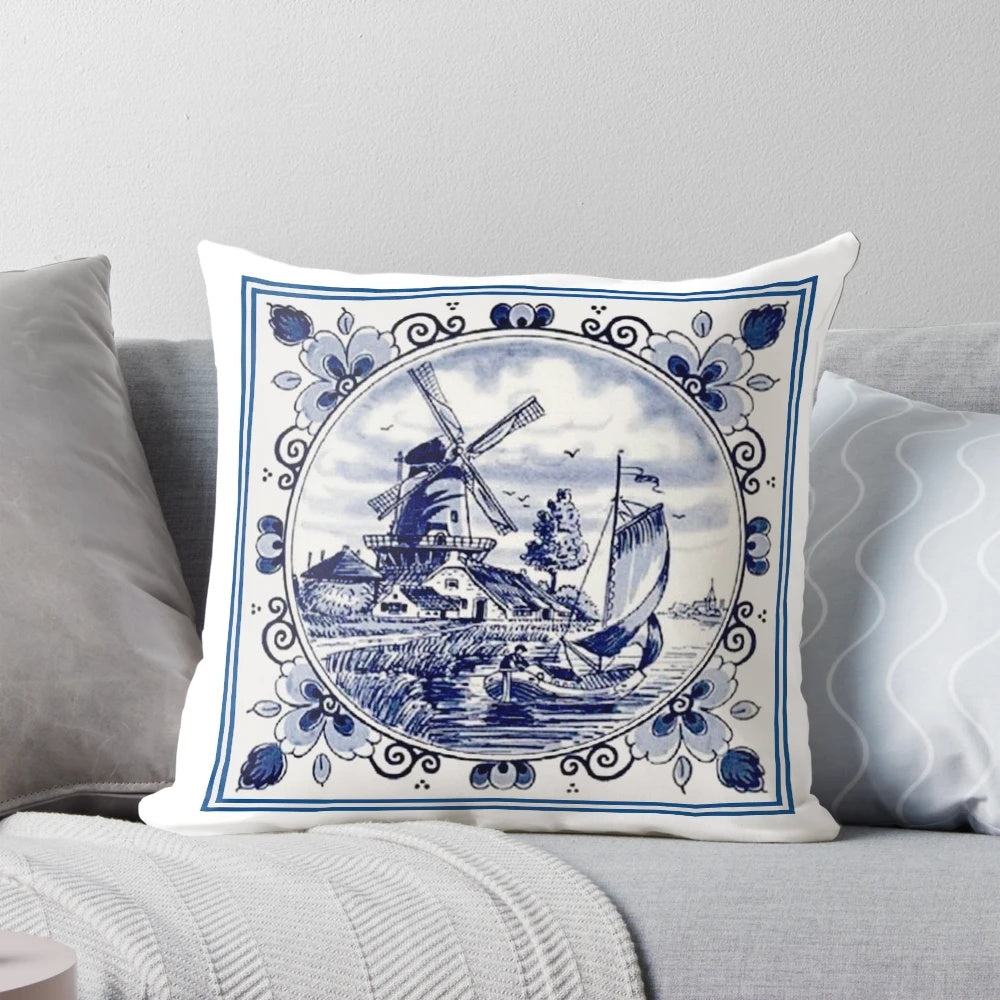 Vintage-inspired blue and white printed pillow featuring a Dutch Delft style windmill scene