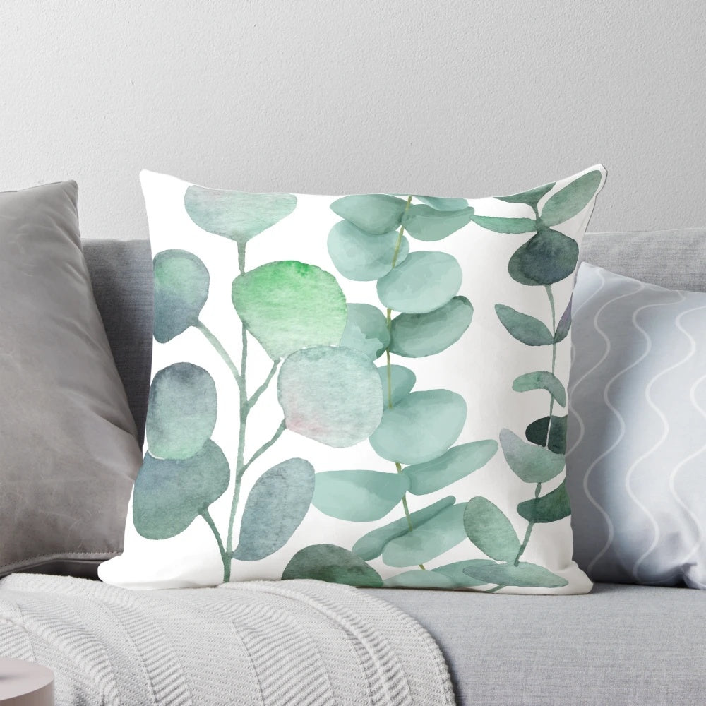 Watercolor painting of green eucalyptus leaves on a decorative cushion for home decor