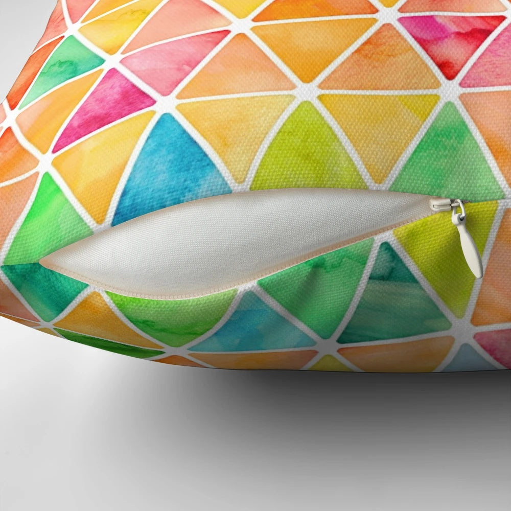 A vibrant, watercolor-style pillow featuring a geometric pattern of colorful triangles against a white background.