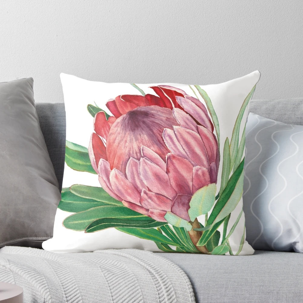 Watercolor painting of a vibrant protea flower on a decorative pillow.