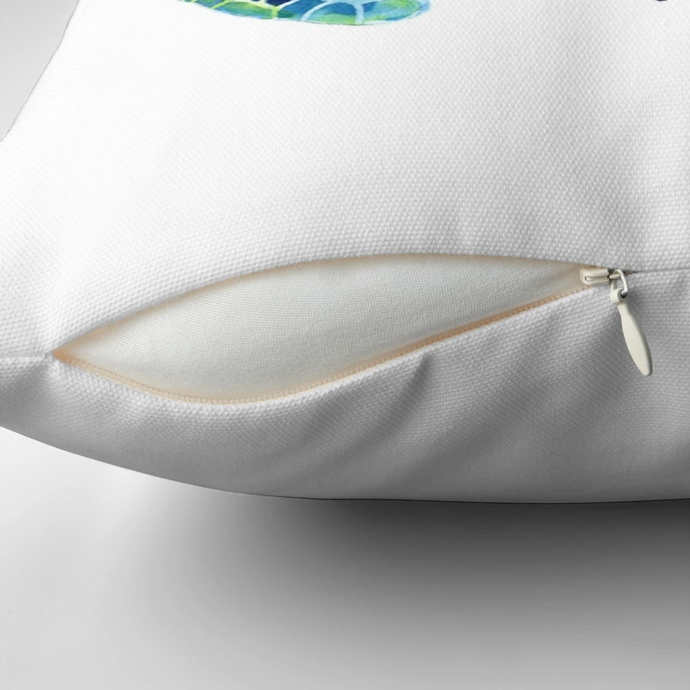 Vibrant watercolor image of a sea turtle on a plush, coastal-inspired pillow.