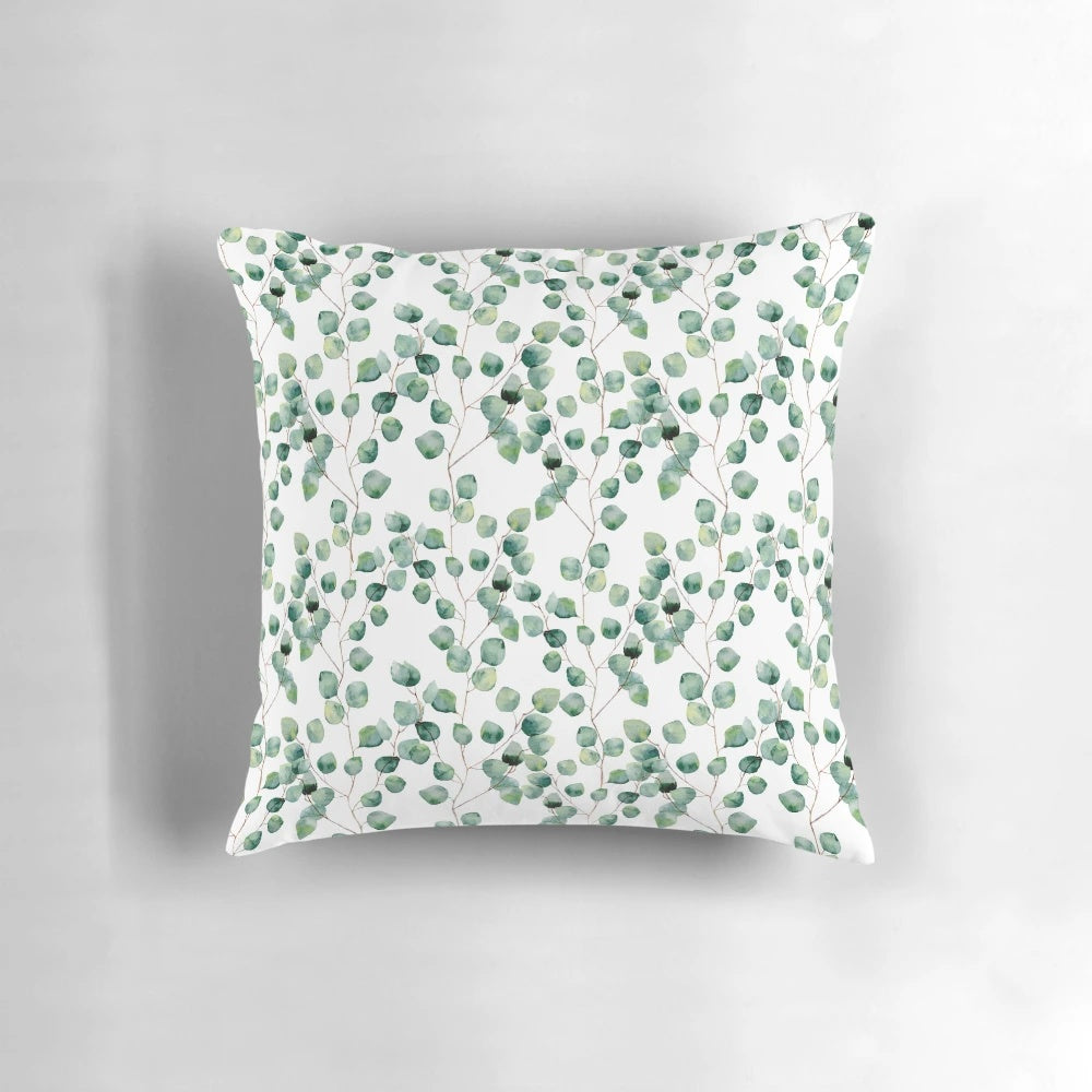 Soft, watercolor-inspired silver dollar eucalyptus pattern on a plush pillow.