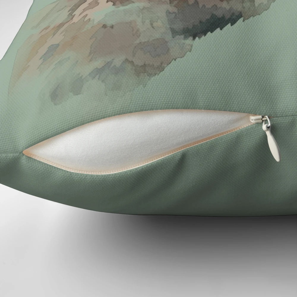 A watercolor-style illustration of a majestic stag with antlers set against a green woodland background on a throw pillow.