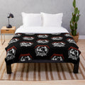 Xenomorph-inspired plush blanket with black and metallic design